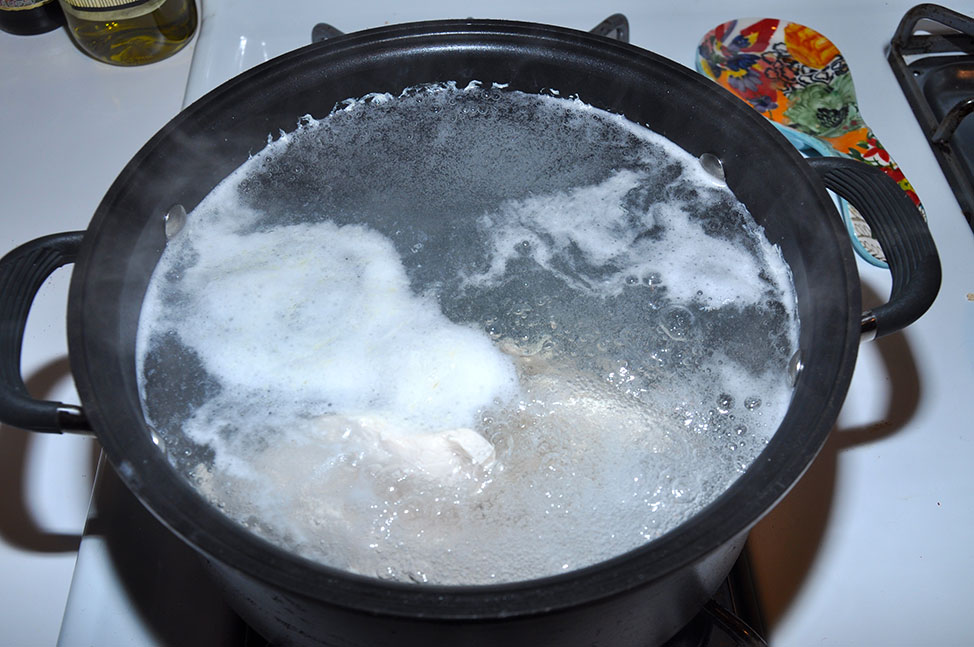 Boiling the chicken for the first time and waiting for the foam to form