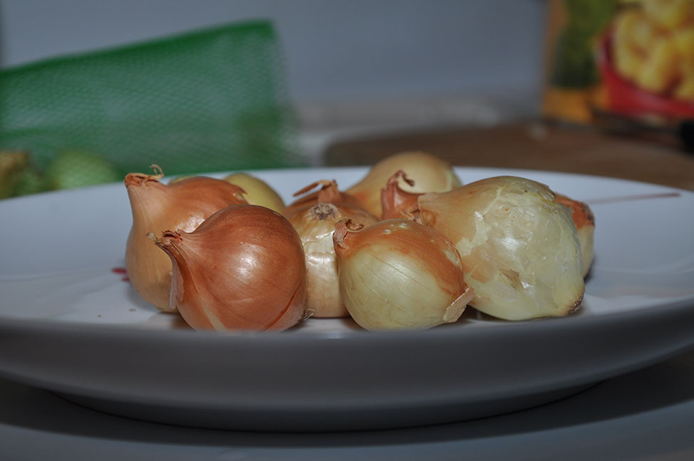 A plate of small unpeeled onions
