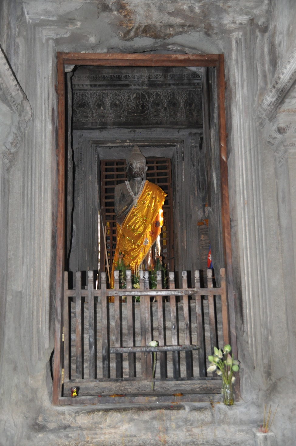 Image of Buddha statue draped in gold fabric