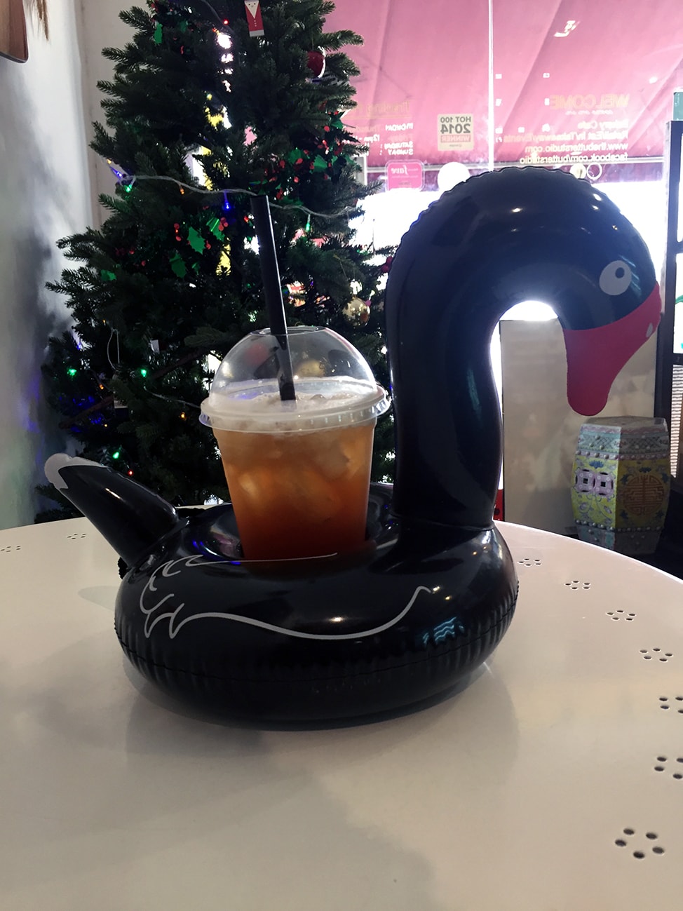 Iced tea served with an inflatable black swan.