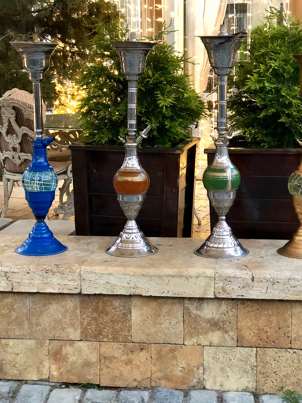 Hookah pipes lined up along a restaurant wall 