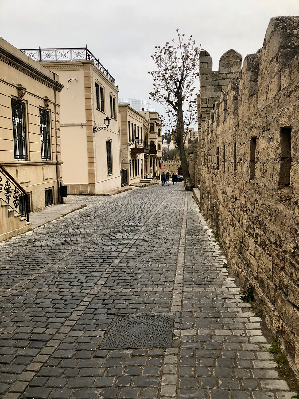 Cobble stone streets lined by brick walls and private homes