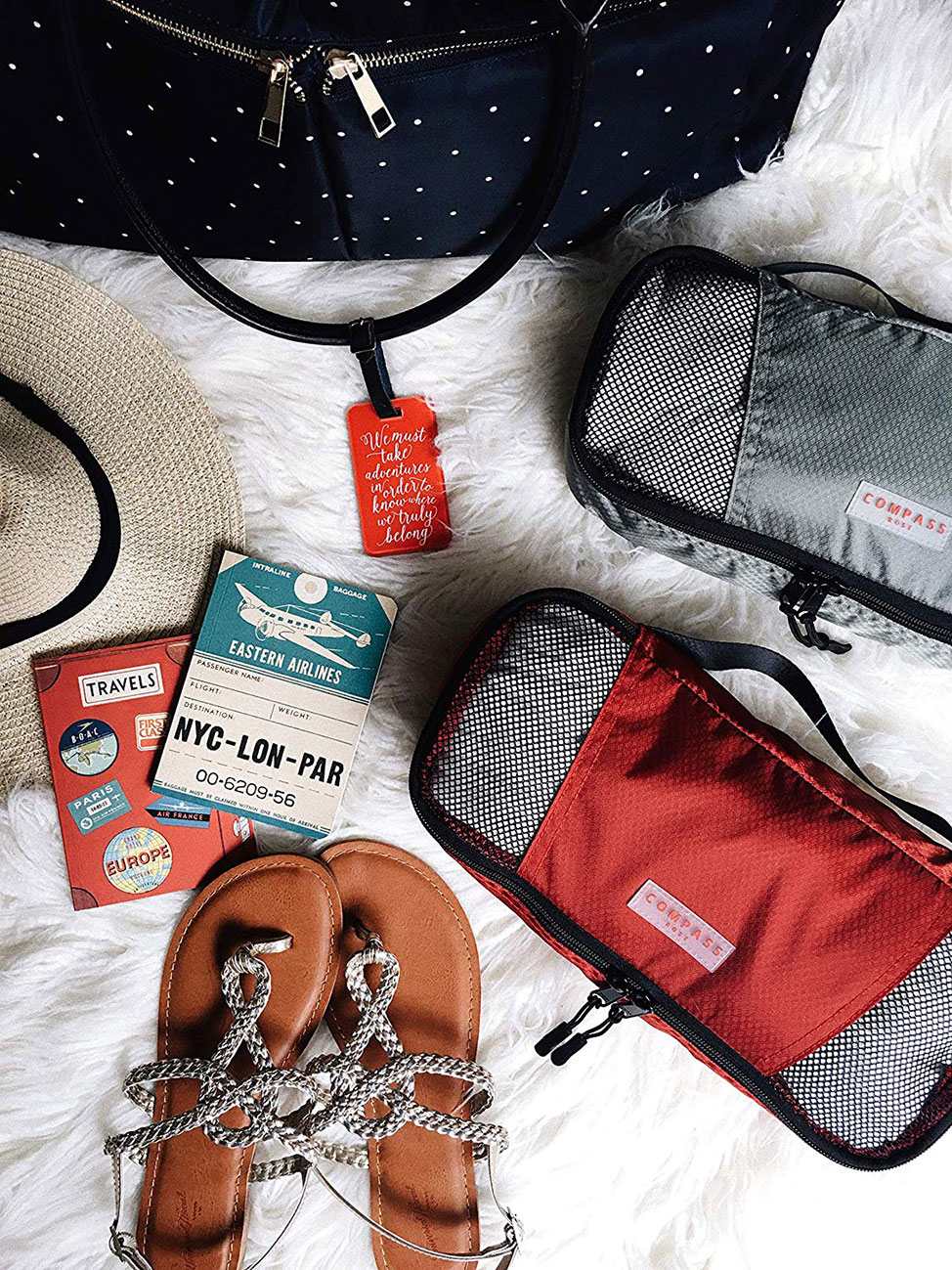 Flat lay image of the Compass Rose Packing Cubes and other travel items