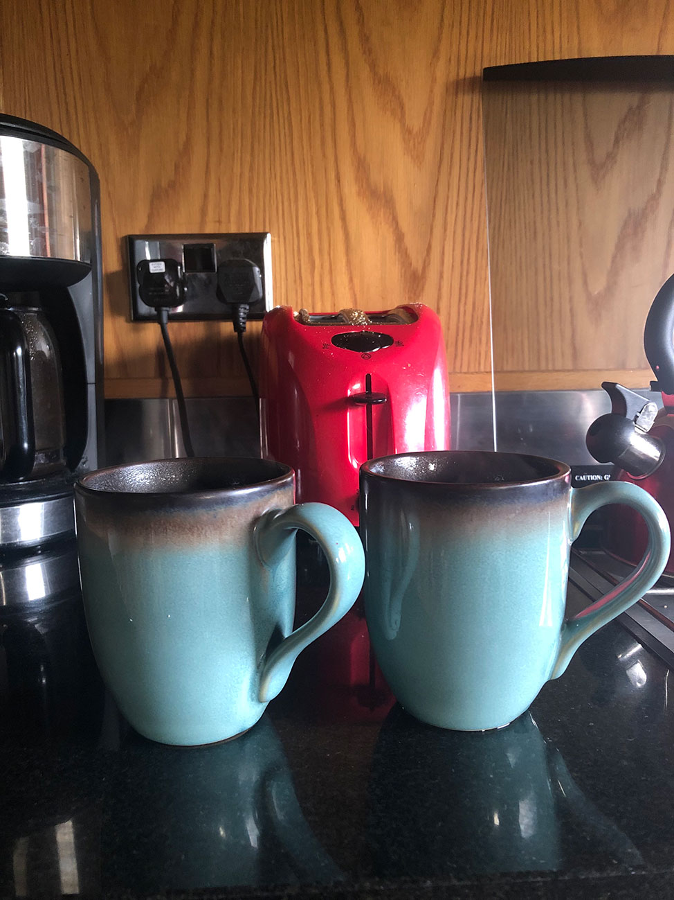Two mugs of coffee in the houseboat's galley.