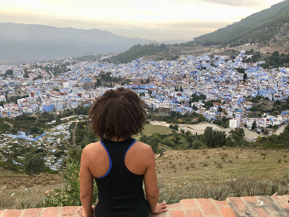 View of a Solo Traveler overlooking Chefchaouen, Morocco. 